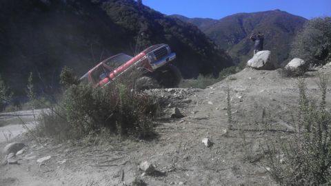 1978 Ford Bronco - This red 1978 Ford Bronco navigates a challenging off-road course with steep inclines and rocky terrain.