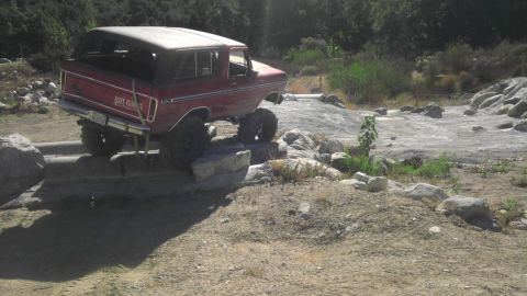 1978 Ford Bronco - This red 1978 Ford Bronco is shown tackling a challenging rocky obstacle course.