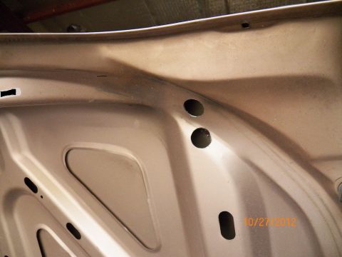 1993 Ford Crown Victoria - The underside of a car hood is shown, with a date stamp and website visible.