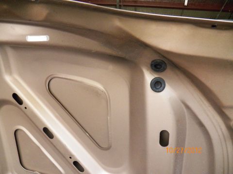 1993 Ford Crown Victoria - The underside of a car hood is visible, showing structural details and a date stamp.