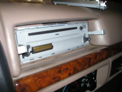 1996 Ford Bronco - Installing a car stereo involves connecting the wiring harness to the mounting bracket.