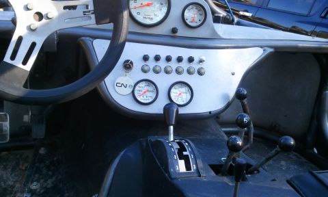 1967 Ford Mustang - Interior view of a custom buggy, a steering wheel, dashboard with gauges, and shifters.