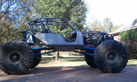 1967 Ford Mustang - A custom-built buggy with a roll cage and oversized tires sits parked outdoors.
