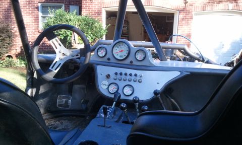 1967 Ford Mustang - The interior of a custom-built buggy shows a modified dashboard with multiple gauges and switches.