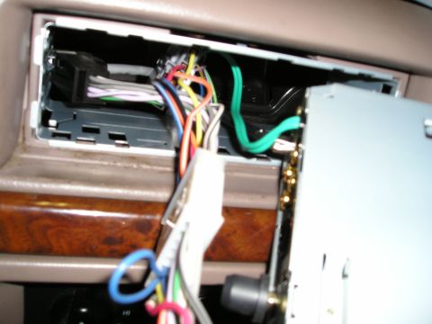 1996 Ford Bronco - Close-up view of a car's dashboard showing exposed wiring and an open space for a stereo installation.