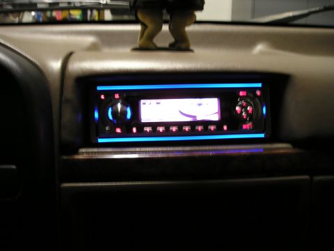 1996 Ford Bronco - Aftermarket car stereo installed in the dashboard, blue and red accent lighting.