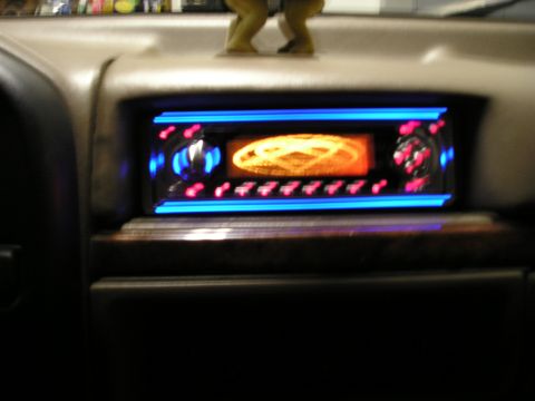1996 Ford Bronco - Aftermarket car stereo with glowing blue and orange lights installed in a vehicle's dashboard.
