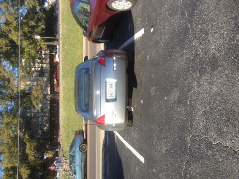 1996 Ford Bronco - Rear view of a silver Nissan 350Z parked in a lot next to other vehicles.