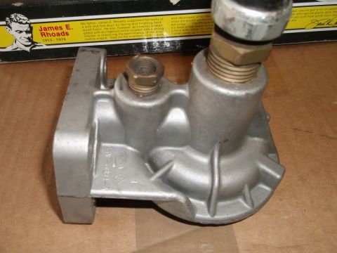 1971 Ford Ranchero - A metal fuel pump with brass fittings is shown, with a box containing biographical text in the background.