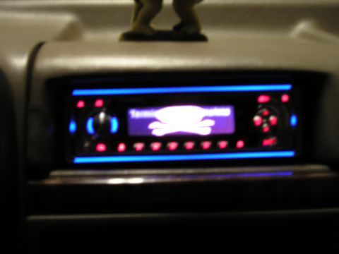 1996 Ford Bronco - Aftermarket car stereo with a skull and crossbones graphic displayed on its screen, installed in a vehicle's dashboard.