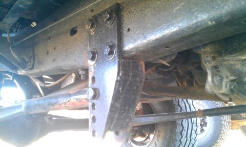 1987 Ford Bronco - Close-up of the undercarriage, highlighting a custom-mounted bracket on the frame.