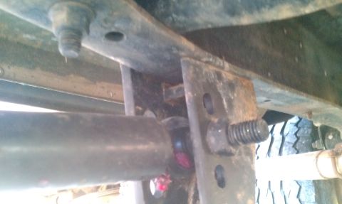 1987 Ford Bronco - Underside view of vehicle chassis components, including frame, driveshaft, and bracketry.