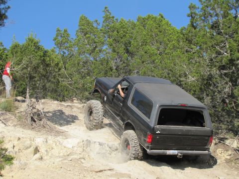 1995 Ford Bronco - This 1995 Ford Bronco navigates a challenging off-road trail with steep inclines and rocky obstacles.