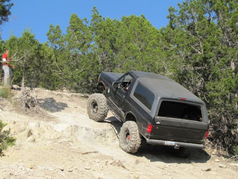1995 Ford Bronco - This 1995 Ford Bronco is navigating challenging off-road terrain on a sunny day.