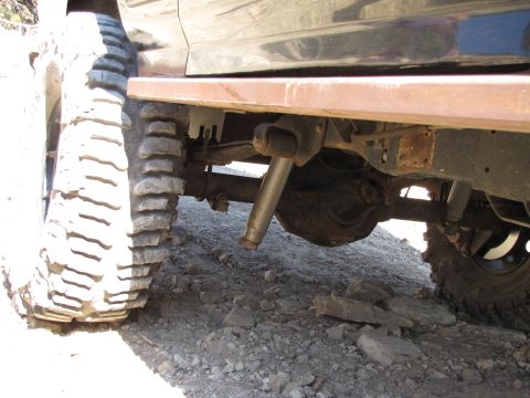 1995 Ford Bronco - The rear axle and suspension components are visible on this 1995 Ford Bronco, equipped with large off-road tires.