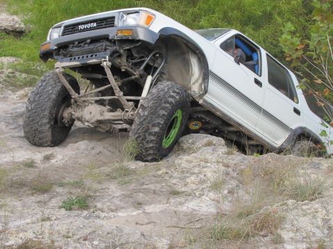 1995 Ford Bronco - This modified Toyota navigates a challenging rocky obstacle course, its off-road capabilities.
