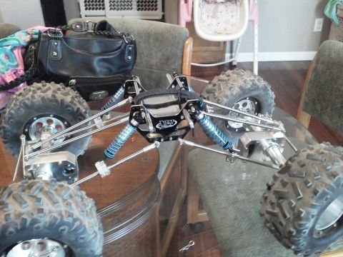 1985 Ford Bronco - This is a remote control rock crawler chassis with large tires and blue shocks, not a 1985 Ford Bronco.
