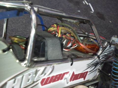 1985 Ford Bronco - Close-up view of the interior of a remote control car, revealing its complex wiring and roll cage structure.
