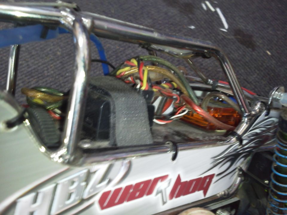 Interior of a remote control car showing exposed wiring and roll cage