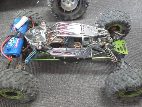 1985 Ford Bronco - This remote-controlled rock crawler features a detailed chassis and off-road tires, with another RC vehicle partially visible.
