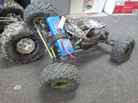 1985 Ford Bronco - This remote control rock crawler features a chrome body and a prominent blue battery pack.