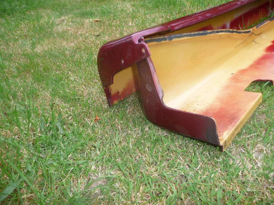 Maroon side skirt part on grass