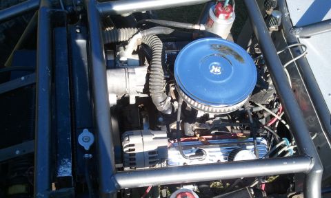 1967 Ford Mustang - Close-up view of a custom engine bay, chrome valve covers and a blue air filter assembly.