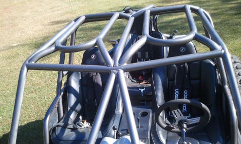 1967 Ford Mustang - Interior view of a custom buggy, a prominent roll cage and racing seats.