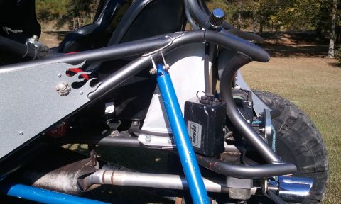 1967 Ford Mustang - Close-up of a custom buggy's rear suspension, a blue shock absorber and a black fluid reservoir.