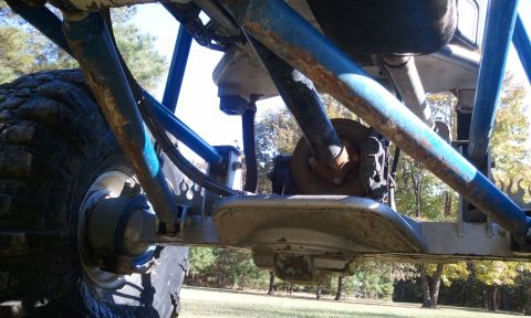 1967 Ford Mustang - The underside of a custom buggy shows its suspension components and large off-road tires.