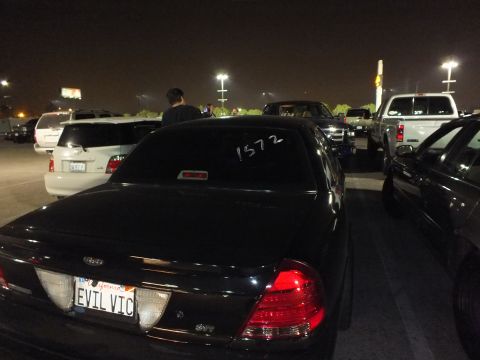 2003 Ford Crown Victoria - Black Crown Victoria from behind, plate reading EVTLVIC and 1572 written on the back window