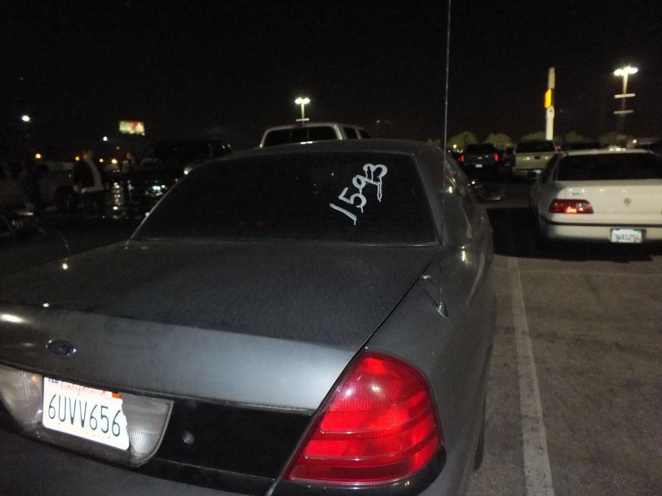 Gray Ford Crown Victoria rear with plate 6UVV656 and 1593 written on rear window at night