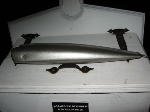 1994 Ford Bronco - A silver exhaust pipe is mounted on a white wooden box with decorative black hardware and a nameplate.