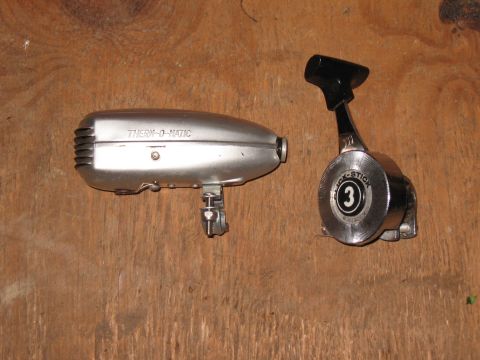 1994 Ford Bronco - Two parts, a Thermo-O-Matic device and a Click-Stick throttle control, are laid out on a wooden surface.