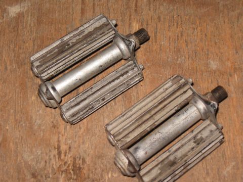 1994 Ford Bronco - Two vintage bicycle pedals shown on a wooden surface.