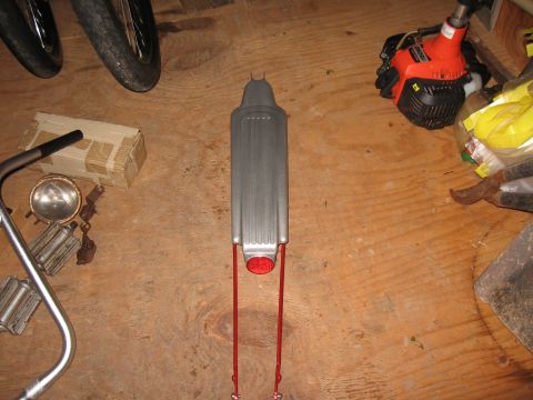 1994 Ford Bronco - A bicycle fender and handlebars are laid out on a wooden surface, alongside other parts and tools.