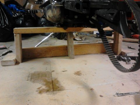2003 Harley-Davidson Sportster - Motorcycle engine assembly resting on a makeshift wooden support.
