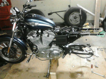 2003 Harley-Davidson Sportster - A motorcycle is shown on a stand in a workshop, with some parts removed for maintenance or after maintenance.