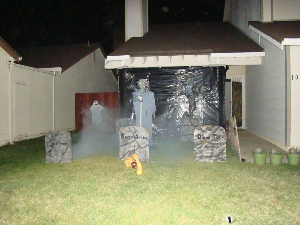 Halloween yard decorations with tombstones and fog