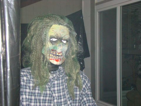 1989 Ford Bronco - A spooky zombie decoration with a creepy mask and disheveled hair is set up for Halloween.