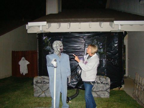 1989 Ford Bronco - Halloween decorations include a zombie figure, tombstones, and a ghost on a fence.