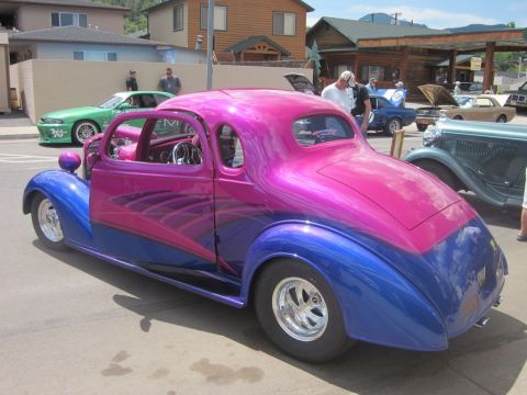 1991 Ford LTD Crown Victoria - Custom hot rod coupe with unique paint scheme at a car show, with other vehicles in the background.