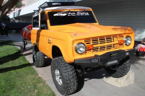 1990 Ford Bronco - This vintage Ford Bronco features a lifted suspension, off-road tires, and a custom front bumper with LED lights.