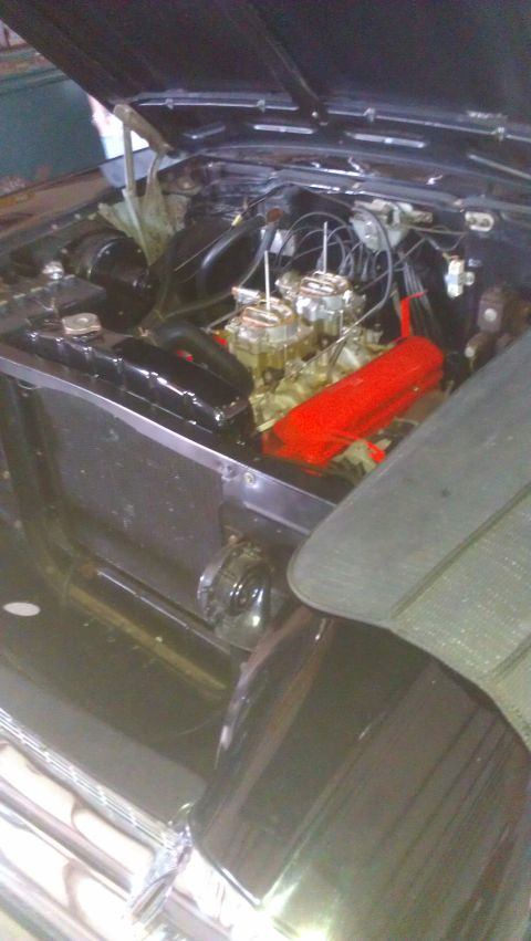 1973 Chevrolet Camaro - The engine bay features dual carburetors and bright red valve covers, suggesting a performance-oriented setup.