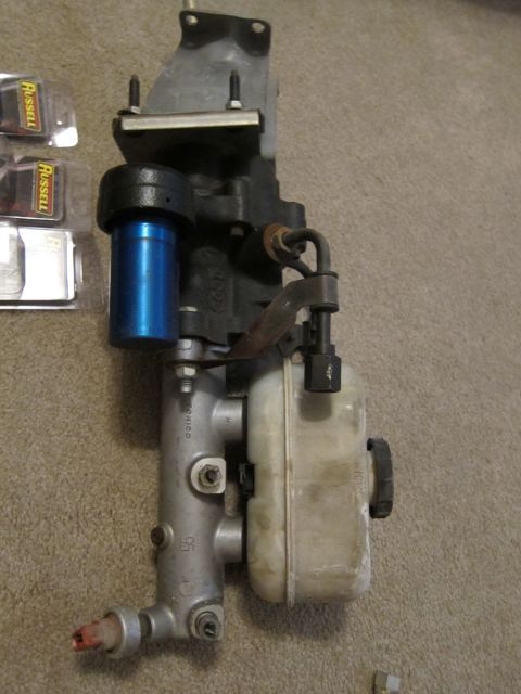 1979 Ford Bronco - A brake master cylinder assembly is shown with a blue cap on its reservoir.