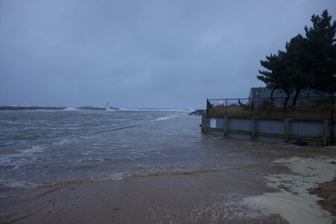 1990 Ford Bronco - A coastal scene shows significant flooding with waves crashing ashore and a lighthouse visible on the horizon.