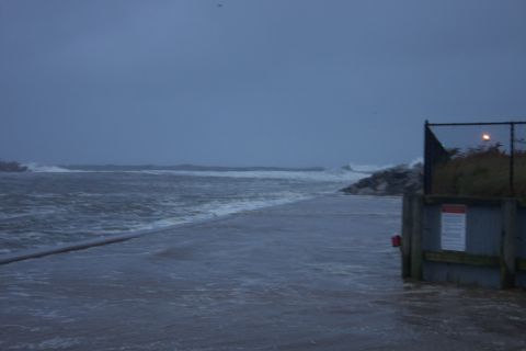 1990 Ford Bronco - Ocean scene during a storm with rough waves and a pier structure.