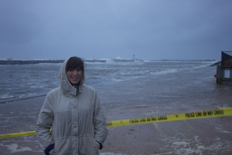 1990 Ford Bronco - A person stands on a beach with yellow police tape in the foreground and stormy seas in the background.