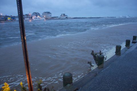 1990 Ford Bronco - Coastal town flooded during a storm, with rough water covering the land.