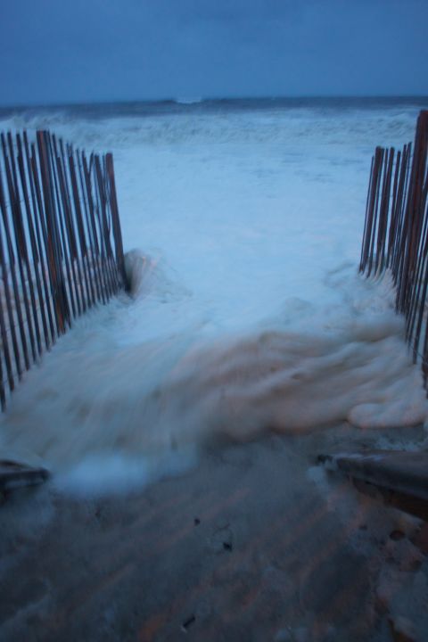 1990 Ford Bronco - Sea foam surges through a beach access fence during a storm.